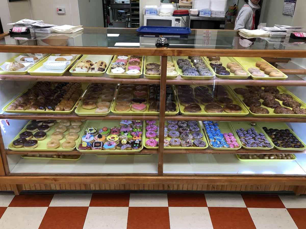 Fresh and custom decorated doughnuts in the display case at Sublett Doughnuts