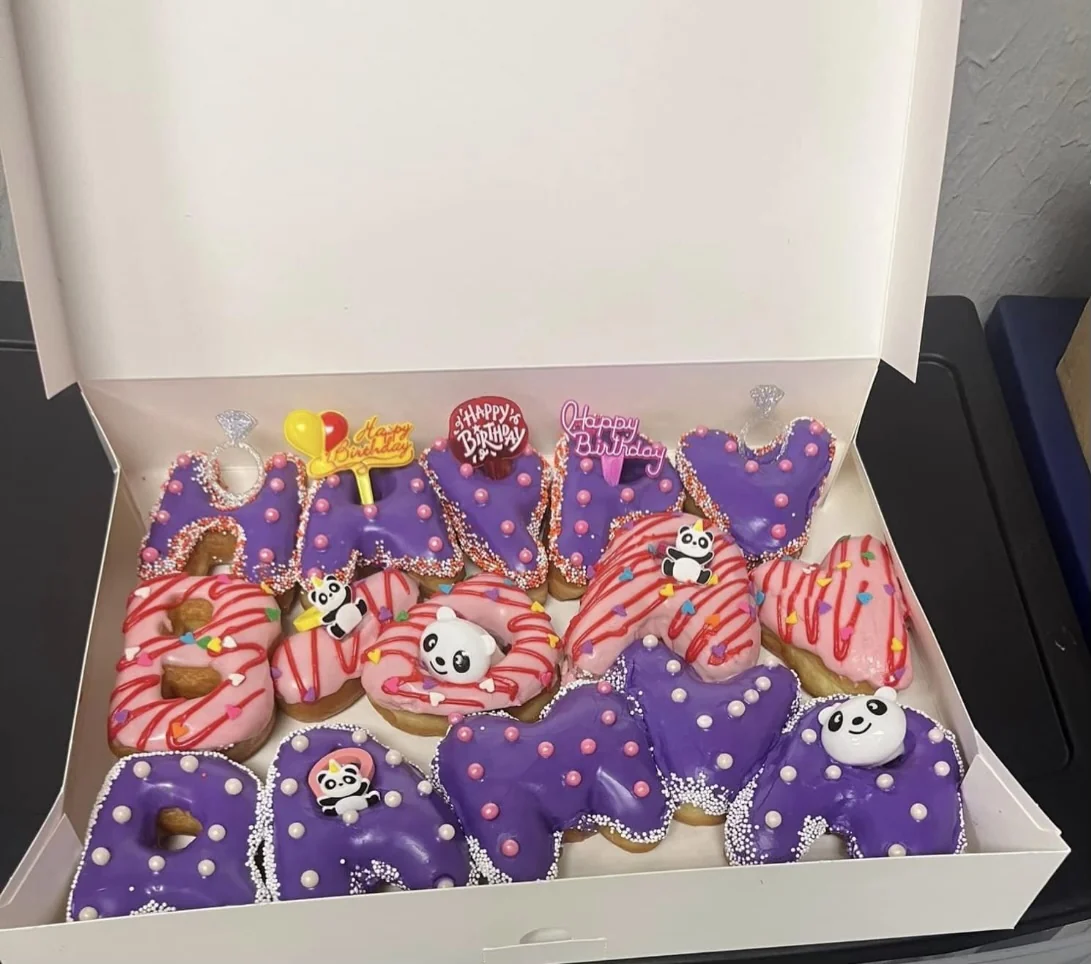 Custom Happy Birthday letter donuts in pink and purple with panda decorations